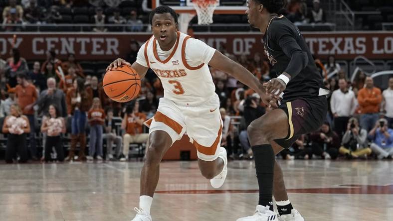 Nov 30, 2023; Austin, Texas, USA; Texas Longhorns 
guard Max Abmas (3) looks to pass the ball while defended by Texas State Bobcats guard Dylan Dawson (0) during the second half at Moody Center. Mandatory Credit: Scott Wachter-USA TODAY Sports