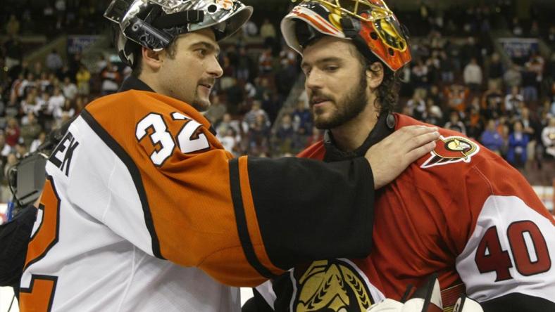 Ottawa Senators goalie Patrick Lalime (R) is congratulated by Philadelphia Flyers goalie Roman Cechmanek after the Senators won the NHL Eastern conference semi-finals at First Union Center in Philadelphia, May 5, 2003. Ottawa defeated Philadelphia 5-1, and won the series four games to two.