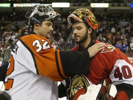 Ottawa Senators goalie Patrick Lalime (R) is congratulated by Philadelphia Flyers goalie Roman Cechmanek after the Senators won the NHL Eastern conference semi-finals at First Union Center in Philadelphia, May 5, 2003. Ottawa defeated Philadelphia 5-1, and won the series four games to two.
