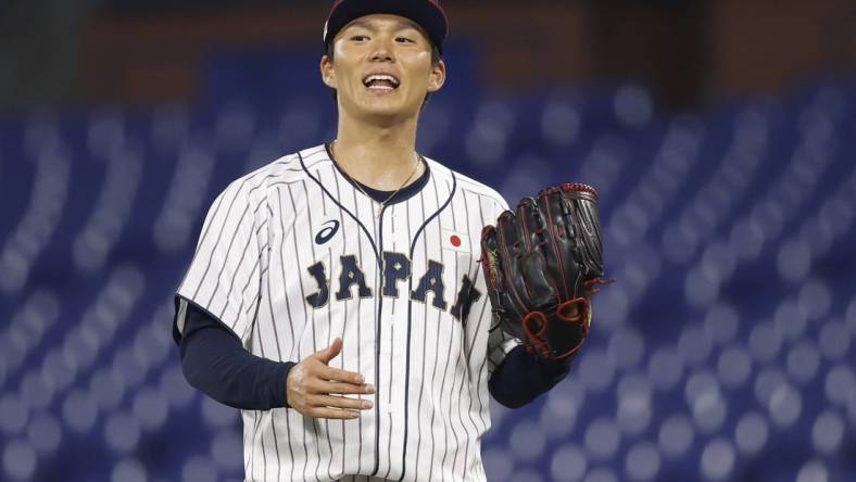 Aug 4, 2021; Yokohama, Japan; Team Japan pitcher Yoshinobu Yamamoto (17) reacts against Korea in a baseball semifinal match during the Tokyo 2020 Olympic Summer Games at Yokohama Baseball Stadium. Mandatory Credit: Yukihito Taguchi-USA TODAY Sports