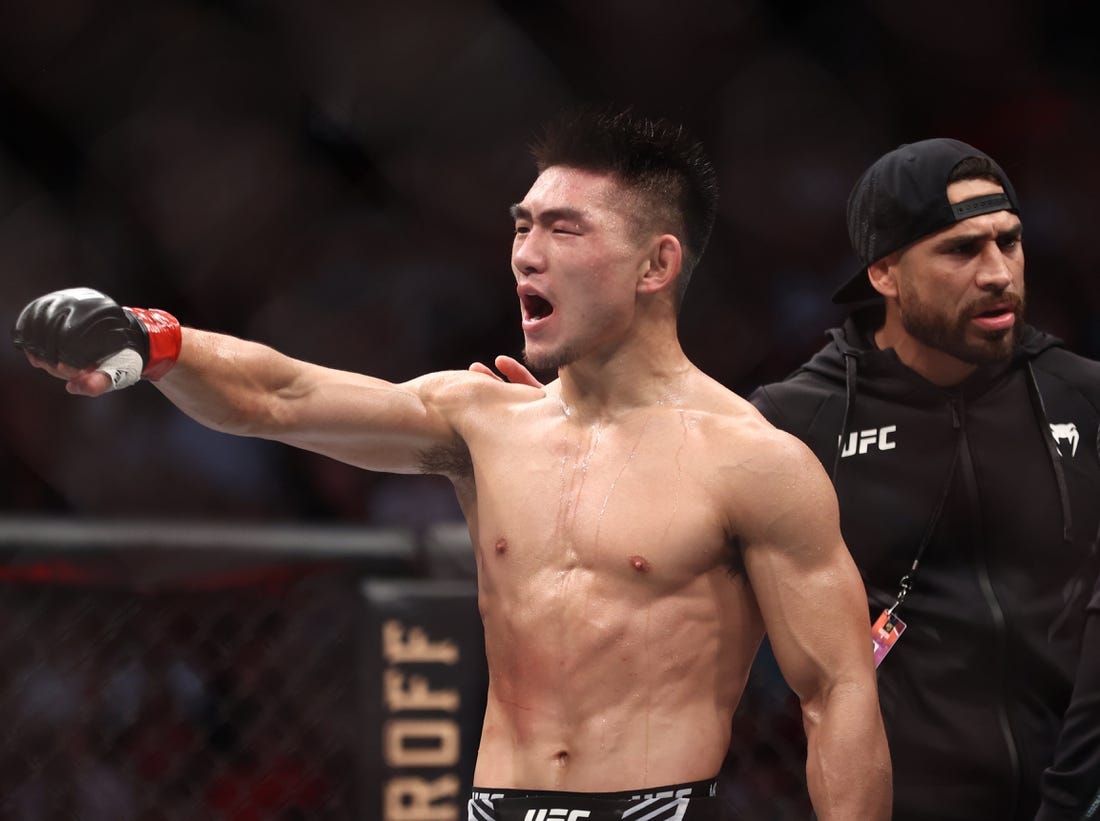 Aug 7, 2021; Houston, Texas, USA; Song Yadong (red gloves) reacts to fight against Casey Kenney (blue gloves) during UFC 265 at Toyota Center. Mandatory Credit: Troy Taormina-USA TODAY Sports