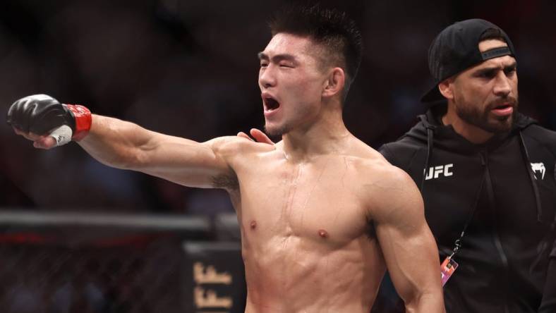 Aug 7, 2021; Houston, Texas, USA; Song Yadong (red gloves) reacts to fight against Casey Kenney (blue gloves) during UFC 265 at Toyota Center. Mandatory Credit: Troy Taormina-USA TODAY Sports