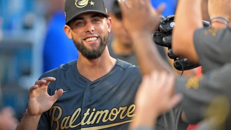 Jul 19, 2022; Los Angeles, California, USA; American League relief pitcher Jorge Lopez (48) of the Baltimore Orioles smiles as he gets high fives in the dugout after pitching against the National League during the seventh inning of the 2022 MLB All Star Game at Dodger Stadium. Mandatory Credit: Jayne Kamin-Oncea-USA TODAY Sports