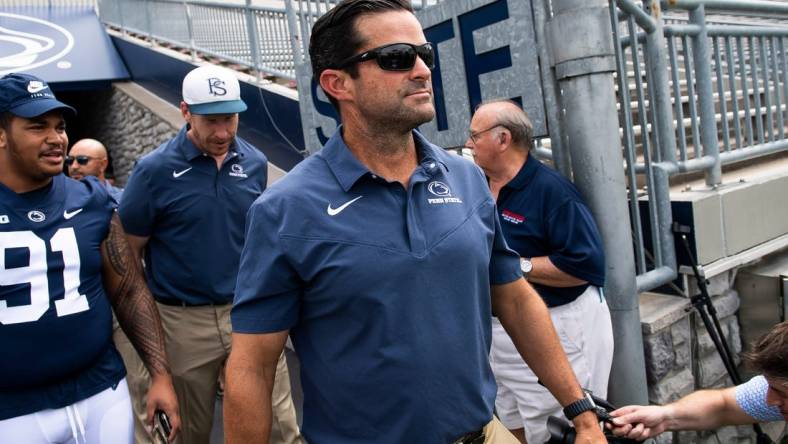 Penn State football defensive coordinator Manny Diaz walks onto the turf with other members of the team during football media day at Beaver Stadium on Saturday, August 6, 2022, in State College.

Hes Dr 080622 Psumedia