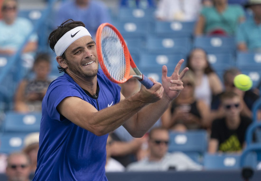 Aug 19, 2022; Cincinnati, OH, USA; Taylor Fritz (USA) returns a shot during his match against Daniil Medvedev (RUS) at the Western & Southern Open at the Lindner Family Tennis Center. Mandatory Credit: Susan Mullane-USA TODAY Sports