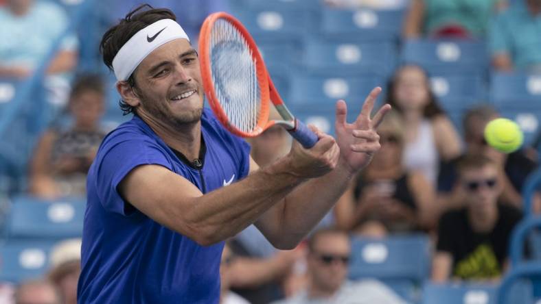 Aug 19, 2022; Cincinnati, OH, USA; Taylor Fritz (USA) returns a shot during his match against Daniil Medvedev (RUS) at the Western & Southern Open at the Lindner Family Tennis Center. Mandatory Credit: Susan Mullane-USA TODAY Sports