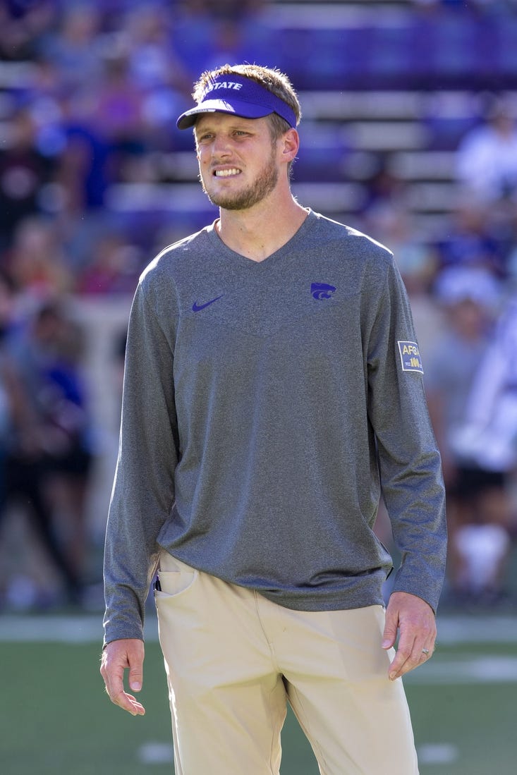 Sep 3, 2022; Manhattan, Kansas, USA; Kansas State Wildcats offensive coordinator Collin Klein watches the team warm up before the start of a game against the South Dakota Coyotes at Bill Snyder Family Football Stadium. Mandatory Credit: Scott Sewell-USA TODAY Sports