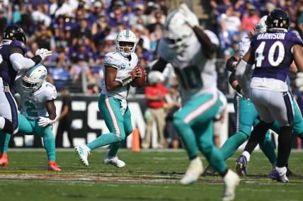 Miami Dolphins quarterback Tua Tagovailoa (1) looks to wide receiver Tyreek Hill (10) during the 2022 matchup with the Baltimore Ravens at M&T Bank Stadium. Mandatory Credit: Tommy Gilligan-USA TODAY Sports