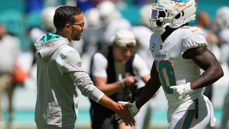 Miami Dolphins head coach Mike McDaniel greets Tyreek Hill during warm-ups before the game against the Buffalo Bills at Hard Rock Stadium in Miami Gardens, Sept. 25, 2022.