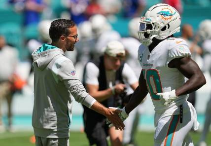 Miami Dolphins head coach Mike McDaniel greets Tyreek Hill during warm-ups before the game against the Buffalo Bills at Hard Rock Stadium in Miami Gardens, Sept. 25, 2022.