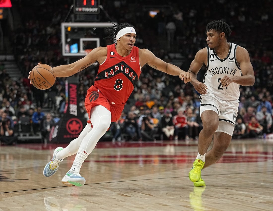 Nov 23, 2022; Toronto, Ontario, CAN; Toronto Raptors guard Ron Harper Jr. (8) drives to the net against b25during the second half at Scotiabank Arena. Mandatory Credit: John E. Sokolowski-USA TODAY Sports