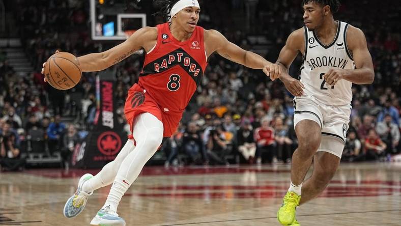 Nov 23, 2022; Toronto, Ontario, CAN; Toronto Raptors guard Ron Harper Jr. (8) drives to the net against b25during the second half at Scotiabank Arena. Mandatory Credit: John E. Sokolowski-USA TODAY Sports