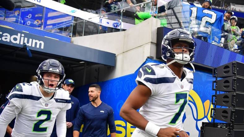 Dec 4, 2022; Inglewood, California, USA; Seattle Seahawks quarterback Geno Smith (7) and quarterback Drew Lock (2) take the field before playing against the Los Angeles Rams at SoFi Stadium. Mandatory Credit: Gary A. Vasquez-USA TODAY Sports