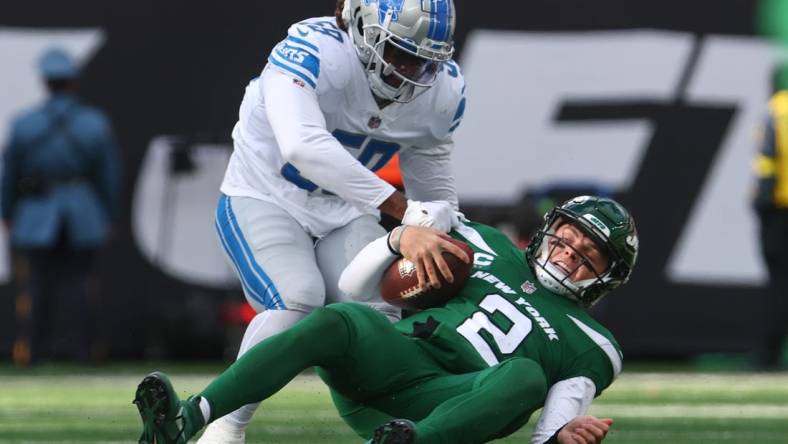 Dec 18, 2022; East Rutherford, New Jersey, USA; New York Jets quarterback Zach Wilson (2) is sacked by Detroit Lions linebacker James Houston (59) during the first half at MetLife Stadium. Mandatory Credit: Ed Mulholland-USA TODAY Sports