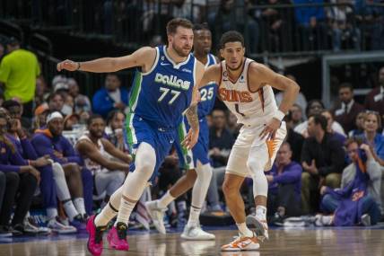 Dec 5, 2022; Dallas, Texas, USA; Phoenix Suns guard Devin Booker (1) and Dallas Mavericks guard Luka Doncic (77) in action during the game between the Dallas Mavericks and the Phoenix Suns at American Airlines Center. Mandatory Credit: Jerome Miron-USA TODAY Sports