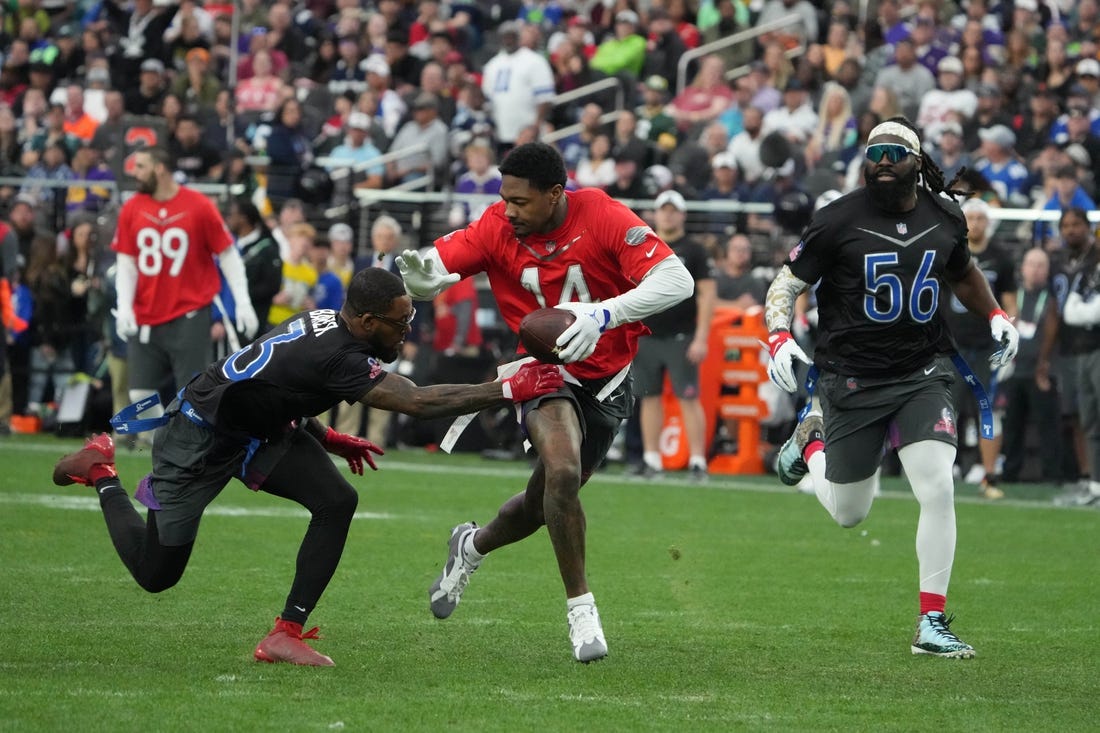 Feb 5, 2023; Paradise, Nevada, USA; AFC receiver Stefon Diggs of the Buffalo Bills (14) carries the ball against NFC strong safety Budda Baker of the Arizona Cardinals (3) and linebacker Demario Davis of the New Orleans Saints (56) during the Pro Bowl Games at Allegiant Stadium. Mandatory Credit: Kirby Lee-USA TODAY Sports