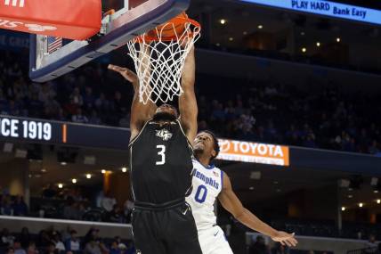 Feb 16, 2023; Memphis, Tennessee, USA; UCF Knights guard Darius Johnson (3) drives to the basket as Memphis Tigers guard Elijah McCadden (0) defends during the second half at FedExForum. Mandatory Credit: Petre Thomas-USA TODAY Sports