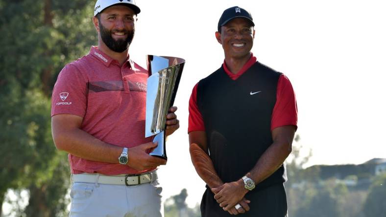 Feb 19, 2023; Pacific Palisades, California, USA; Jon Rahm poses for photos with Tiger Woods following his victory in the final round of The Genesis Invitational golf tournament. Mandatory Credit: Gary A. Vasquez-USA TODAY Sports