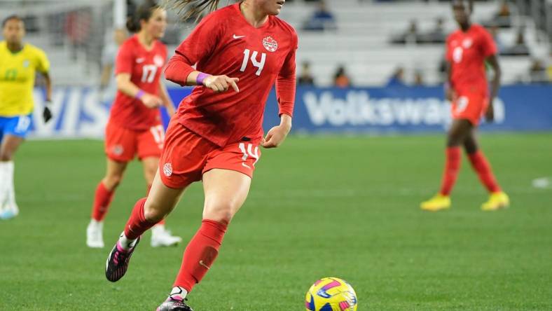 Feb 19, 2023; Nashville, Tennessee, USA;  Canada defender Vanessa Gilles (14) dribbles the ball against Canada during the first half at Geodis Park. Mandatory Credit: Steve Roberts-USA TODAY Sports