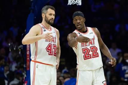 Feb 27, 2023; Philadelphia, Pennsylvania, USA; Miami Heat forward Jimmy Butler (22) talks with forward Kevin Love (42) during a break in action in the second quarter against the Philadelphia 76ers at Wells Fargo Center. Mandatory Credit: Bill Streicher-USA TODAY Sports
