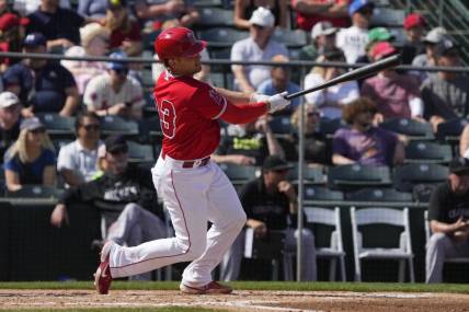 Mar 8, 2023; Tempe, Arizona, USA; Los Angeles Angels catcher Max Stassi (33) hits a single against the Colorado Rockies in the fourth inning at Tempe Diablo Stadium. Mandatory Credit: Rick Scuteri-USA TODAY Sports