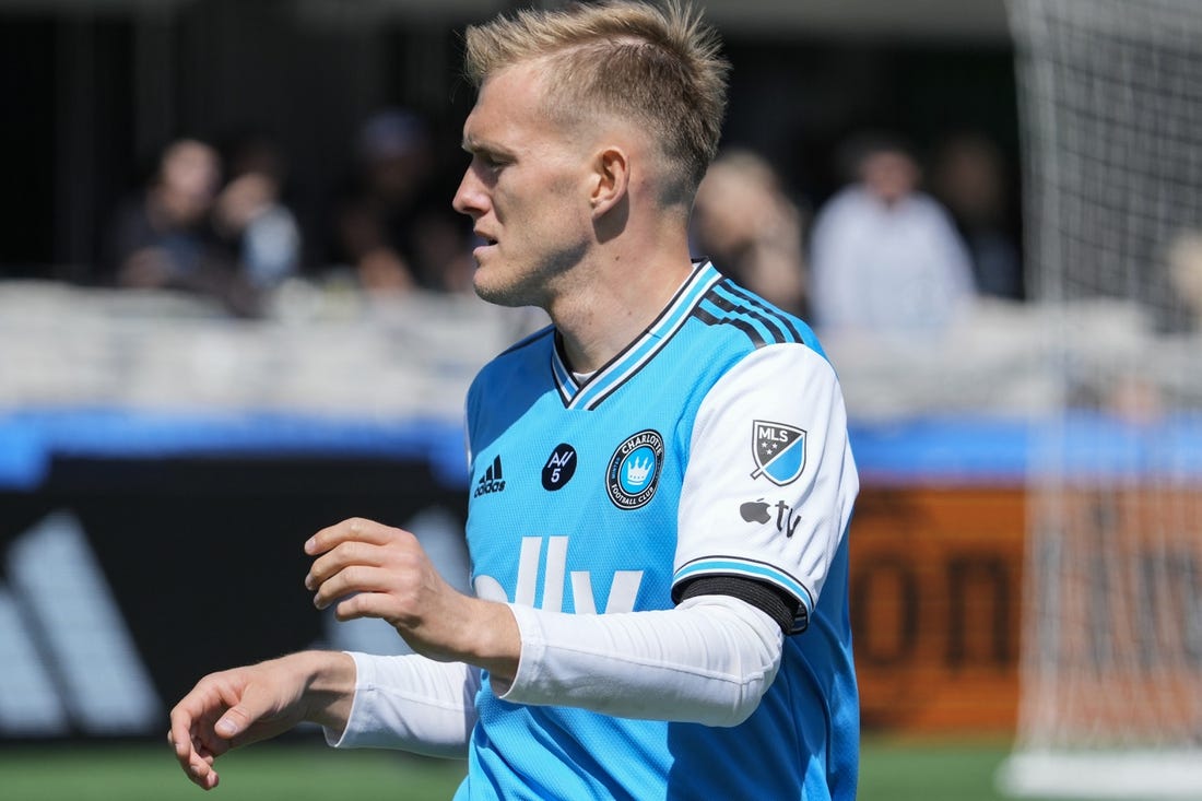 Mar 11, 2023; Charlotte, North Carolina, USA; Charlotte FC forward Karol Swiderski (11) wears the Apple logo on his kit during the first half against the Atlanta United at Bank of America Stadium. Mandatory Credit: Jim Dedmon-USA TODAY Sports