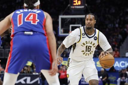 Mar 11, 2023; Detroit, Michigan, USA;  Indiana Pacers forward James Johnson (16) dribbles the ball against Detroit Pistons guard R.J. Hampton (14) in the second half at Little Caesars Arena. Mandatory Credit: Rick Osentoski-USA TODAY Sports