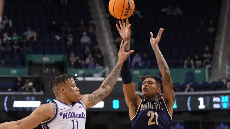 Mar 17, 2023; Greensboro, NC, USA; Montana State Bobcats guard RaeQuan Battle (21) shoots against Kansas State Wildcats forward Keyontae Johnson (11) in the second half at Greensboro Coliseum. Mandatory Credit: Bob Donnan-USA TODAY Sports