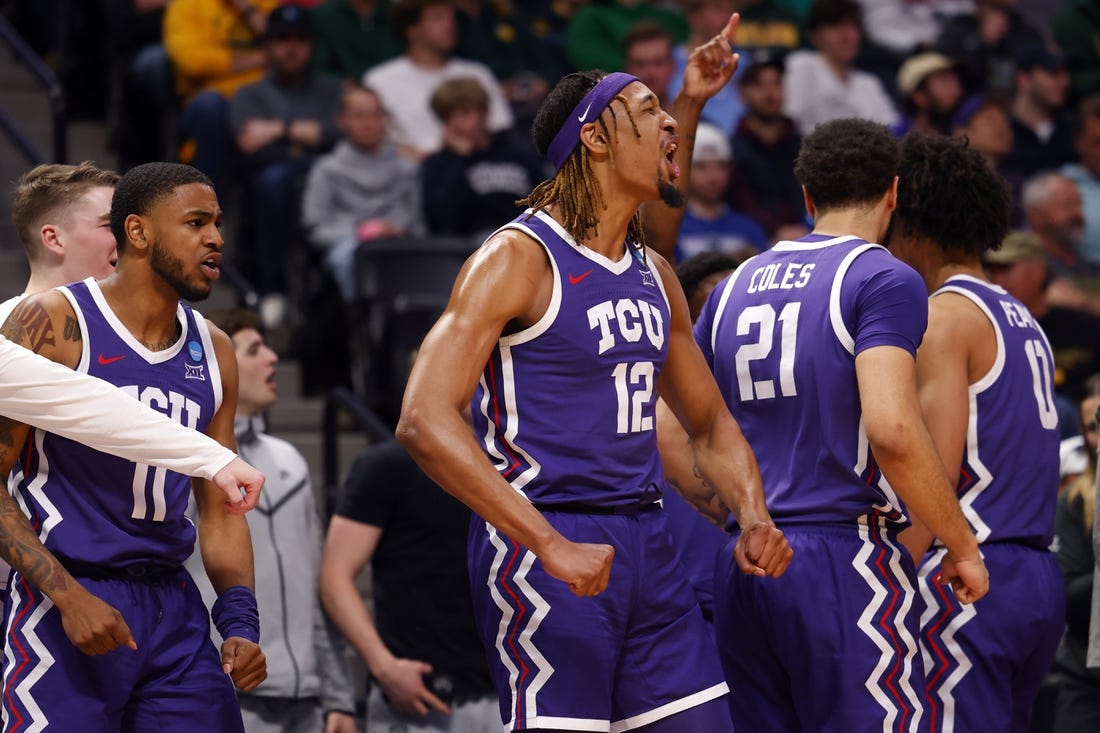Mar 19, 2023; Denver, CO, USA; TCU Horned Frogs forward Xavier Cork (12) and guard Rondel Walker (11) and forward JaKobe Coles (21) celebrate on the bench in the first half against the Gonzaga Bulldogs at Ball Arena. Mandatory Credit: Michael Ciaglo-USA TODAY Sports