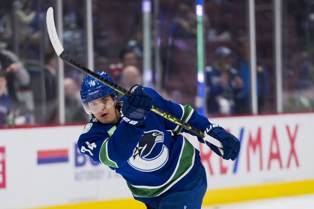 Apr 2, 2023; Vancouver, British Columbia, CAN; Vancouver Canucks defenseman Ethan Bear (74) shoots during warm up prior to a game against the Los Angeles Kings at Rogers Arena. Mandatory Credit: Bob Frid-USA TODAY Sports