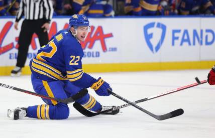 Apr 8, 2023; Buffalo, New York, USA;  Buffalo Sabres right wing Jack Quinn (22) makes a pass as he falls during the second period against the Carolina Hurricanes at KeyBank Center. Mandatory Credit: Timothy T. Ludwig-USA TODAY Sports