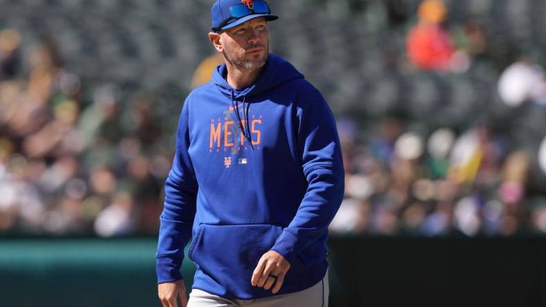 Apr 16, 2023; Oakland, California, USA; New York Mets pitching coach Jeremy Hefner walks to the dugout during the eighth inning against the Oakland Athletics at RingCentral Coliseum. Mandatory Credit: Darren Yamashita-USA TODAY Sports