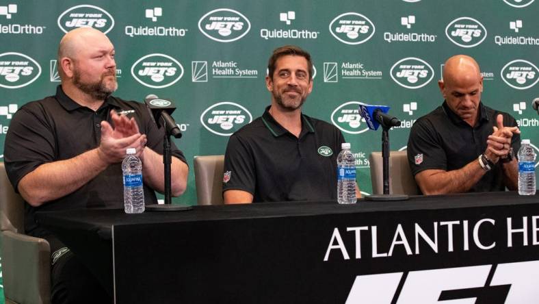 Apr 26, 2023; Florham Park, NJ, USA; New York Jets quarterback Aaron Rodgers (8) (center) is introduced during the introductory press conference alongside general manager Joe Douglas (left) and head coach Robert Saleh (right) at Atlantic Health Jets Training Center. Mandatory Credit: Tom Horak-USA TODAY Sports