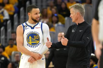 Apr 23, 2023; San Francisco, California, USA; Golden State Warriors guard Stephen Curry (30) talks with head coach Steve Kerr during the third quarter of game four of the 2023 NBA playoffs against the Sacramento Kings at Chase Center. Mandatory Credit: Darren Yamashita-USA TODAY Sports