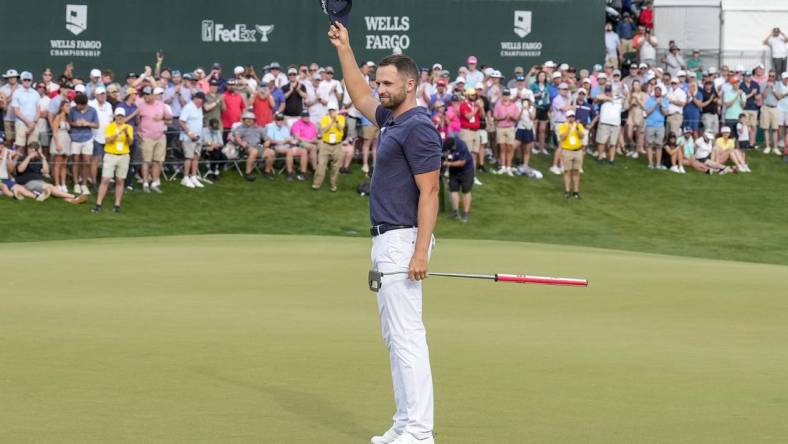 May 7, 2023; Charlotte, North Carolina, USA; Wyndham Clark celebrates to the gallery after his win during the final round of the Wells Fargo Championship golf tournament. Mandatory Credit: Jim Dedmon-USA TODAY Sports