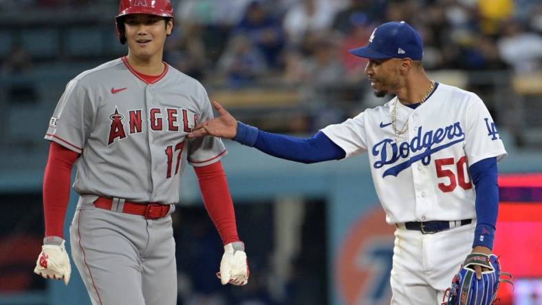 Jul 7, 2023; Los Angeles, California, USA; Los Angeles Angels starting pitcher Shohei Ohtani (17) and Los Angeles Dodgers right fielder Mookie Betts (50) talk while at second base during a play review in the fourth inning at Dodger Stadium. Mandatory Credit: Jayne Kamin-Oncea-USA TODAY Sports