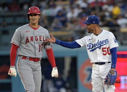 Jul 7, 2023; Los Angeles, California, USA; Los Angeles Angels starting pitcher Shohei Ohtani (17) and Los Angeles Dodgers right fielder Mookie Betts (50) talk while at second base during a play review in the fourth inning at Dodger Stadium. Mandatory Credit: Jayne Kamin-Oncea-USA TODAY Sports