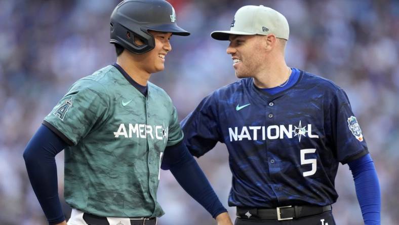 Jul 11, 2023; Seattle, Washington, USA; American League designated hitter/pitcher  Shohei Ohtani  of the Los Angeles Angels of Anaheim (17) reacts with National League first baseman  Freddie Freeman  of the Los Angeles Dodgers (5) during the fifth inning at T-Mobile Park. Mandatory Credit: Stephen Brashear-USA TODAY Sports