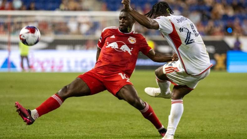 Jul 22, 2023; Harrison, NJ, USA; New York Red Bulls midfielder Dru Yearwood (16) blocks a pass by New England Revolution forward DeJuan Jones (24) during the second half at Red Bull Arena. Mandatory Credit: Mark Smith-USA TODAY Sports