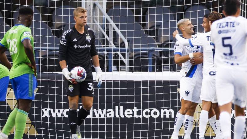 Jul 30, 2023; Seattle, WA, USA; Monterrey forward German Berterame (9, second from right) hugs defender Luis Romo (27) after scoring a goal against Seattle Sounders FC goalkeeper Stefan Cleveland (30) during the second half at Lumen Filed. Mandatory Credit: Joe Nicholson-USA TODAY Sports