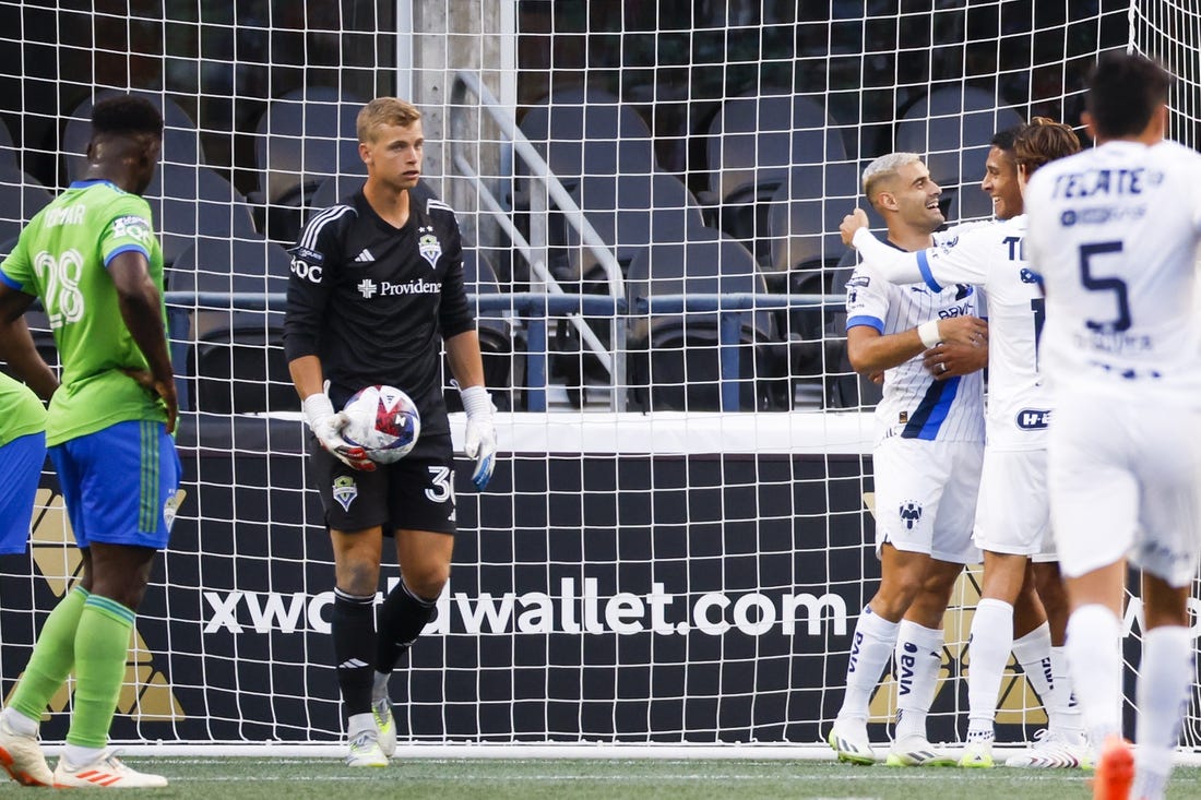 Jul 30, 2023; Seattle, WA, USA; Monterrey forward German Berterame (9, second from right) hugs defender Luis Romo (27) after scoring a goal against Seattle Sounders FC goalkeeper Stefan Cleveland (30) during the second half at Lumen Filed. Mandatory Credit: Joe Nicholson-USA TODAY Sports