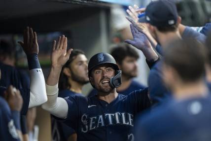 Aug 8, 2023; Seattle, Washington, USA; Seattle Mariners catcher Tom Murphy (2) celebrates in the dugout after scoring a run during the sixth inning against the San Diego Padres at T-Mobile Park. Mandatory Credit: Stephen Brashear-USA TODAY Sports