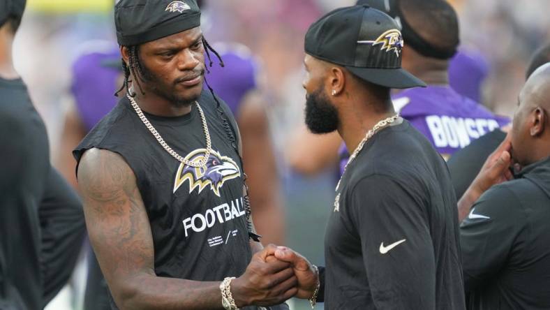 Aug 12, 2023; Baltimore, Maryland, USA; Baltimore Ravens quarterback Lamar Jackson (left) greets wide receiver  Odell Beckham Jr (right) on the sideline during the first quarter against the Philadelphia Eagles at M&T Bank Stadium. Mandatory Credit: Mitch Stringer-USA TODAY Sports