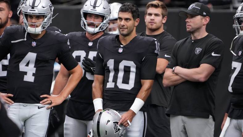 Aug 13, 2023; Paradise, Nevada, USA; Las Vegas Raiders quarterback Jimmy Garoppolo (10) and quarterback Aidan O'Connell (4) watch from the sidelines against the San Francisco 49ers in the first half at Allegiant Stadium. Mandatory Credit: Kirby Lee-USA TODAY Sports