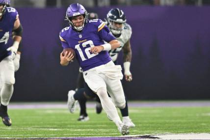 Minnesota Vikings quarterback Nick Mullens (12) runs with the ball against the Tennessee Titans during the second quarter at U.S. Bank Stadium. Mandatory Credit: Jeffrey Becker-USA TODAY Sports