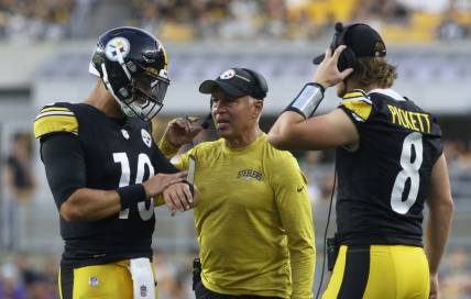 Aug 19, 2023; Pittsburgh, Pennsylvania, USA;  Pittsburgh Steelers quarterbacks Mitch Trubisky (10) and Kenny Pickett (8) talk with quarterbacks coach Mike Sullivan (middle) against the Buffalo Bills during the second quarter at Acrisure Stadium. Mandatory Credit: Charles LeClaire-USA TODAY Sports