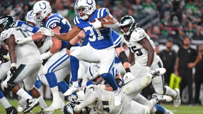 Aug 24, 2023; Philadelphia, Pennsylvania, USA; Indianapolis Colts running back Kenyan Drake (31) leaps over Philadelphia Eagles defensive tackle Caleb Sanders (67) during the fourth quarter at Lincoln Financial Field. Mandatory Credit: Eric Hartline-USA TODAY Sports