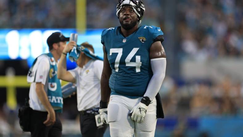 Jacksonville Jaguars offensive tackle Cam Robinson (74) reacts to a catch being confirmed in favor of the Jacksonville Jaguars during the second quarter of a preseason matchup Saturday, Aug. 26, 2023 at EverBank Stadium in Jacksonville, Fla. [Corey Perrine/Florida Times-Union]