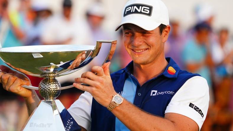 Aug 27, 2023; Atlanta, Georgia, USA; Viktor Hovland celebrate with the FedEx trophy after winning the TOUR Championship golf tournament at East Lake Golf Club. Mandatory Credit: John David Mercer-USA TODAY Sports