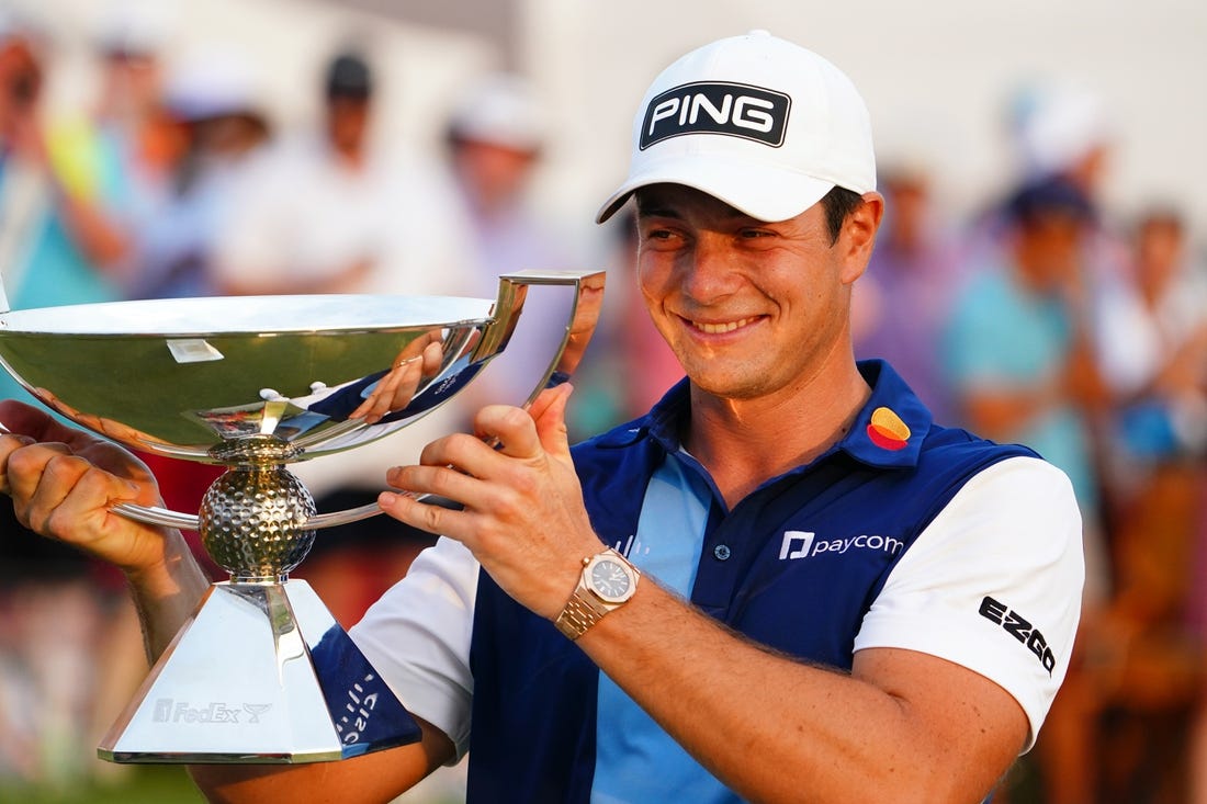 Aug 27, 2023; Atlanta, Georgia, USA; Viktor Hovland celebrate with the FedEx trophy after winning the TOUR Championship golf tournament at East Lake Golf Club. Mandatory Credit: John David Mercer-USA TODAY Sports